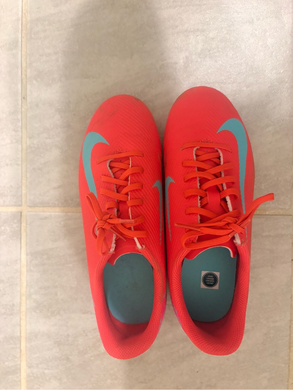 Nike Red Soccer Cleats with Teal Swoosh